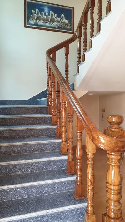 Staircase with polished solid-wood railing and turned balusters